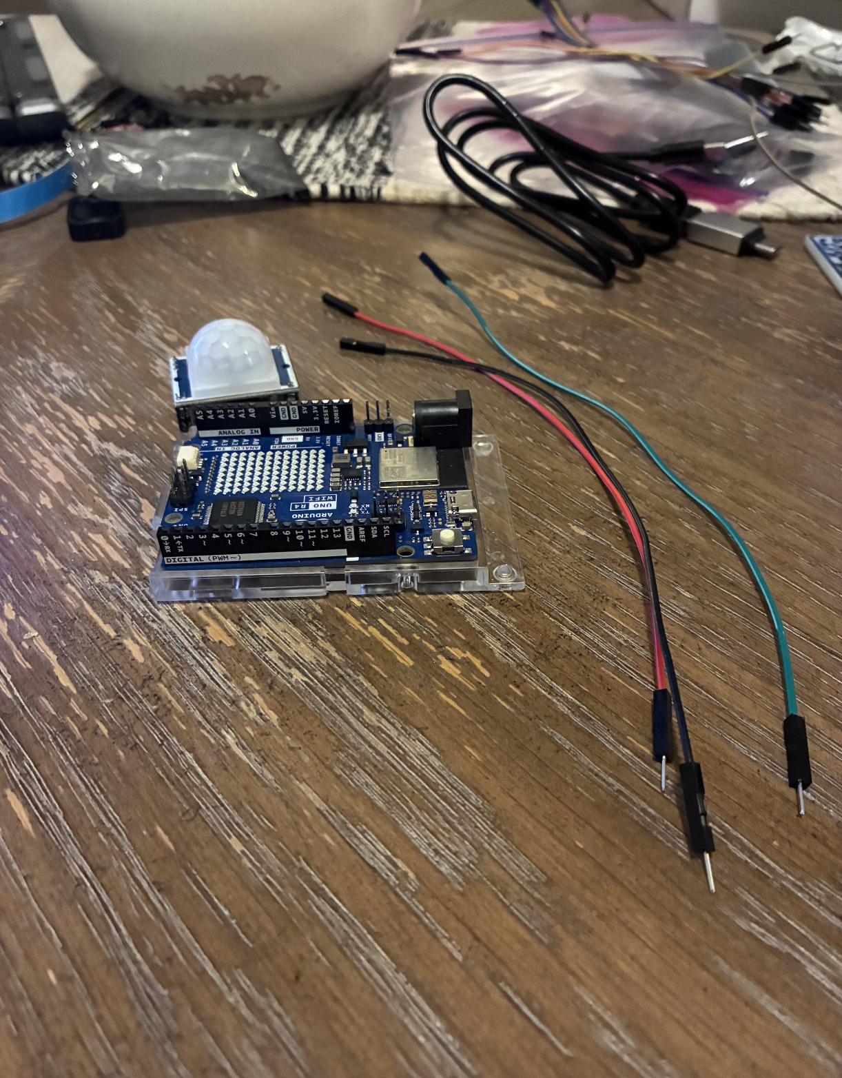 Displays the PIR sensor face, lens, and how it sits within the prototype from the front view.
